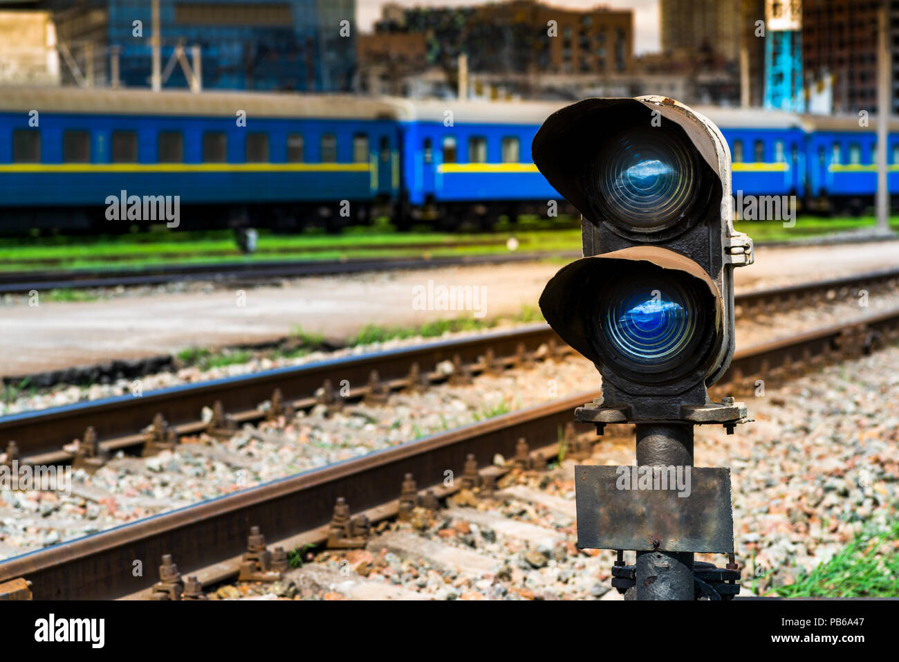 blue signal of the semaphore on the background of the railway track Stock Photo