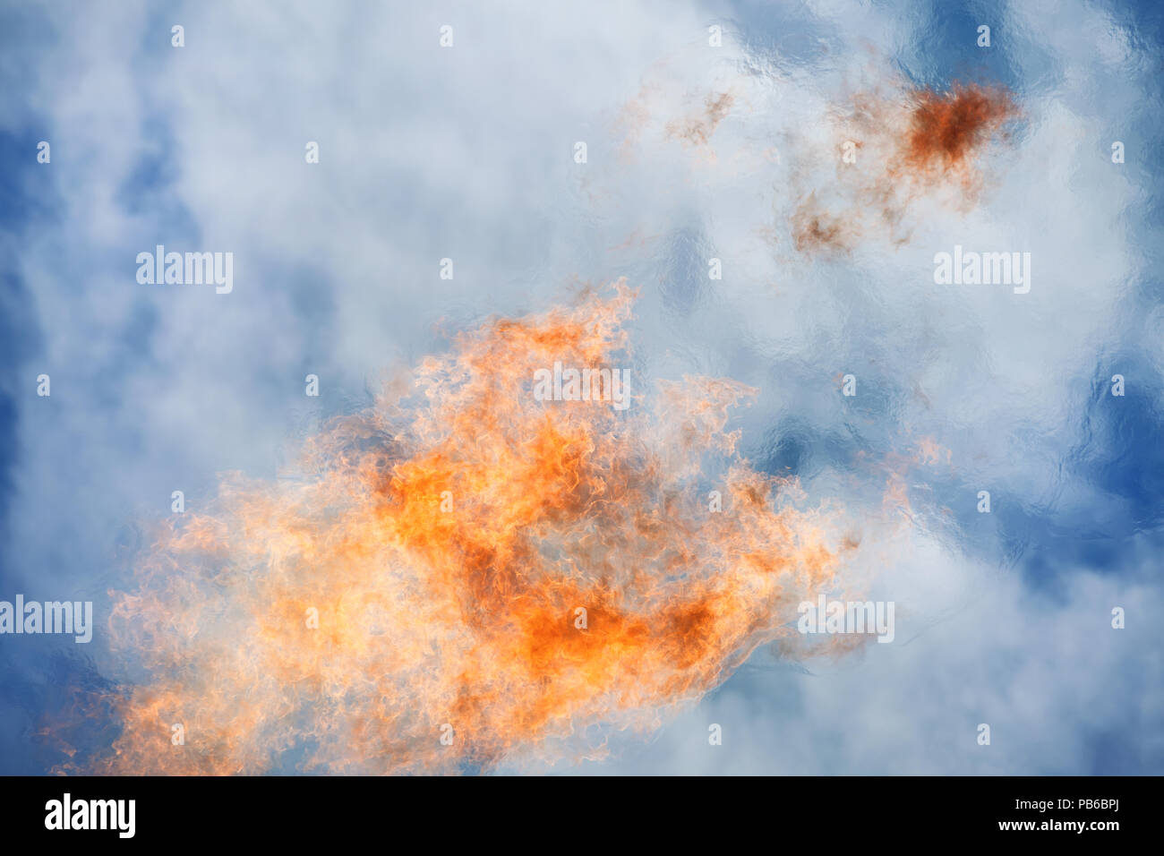 Bright big flame against blue sky. Fire and burning theme Stock Photo