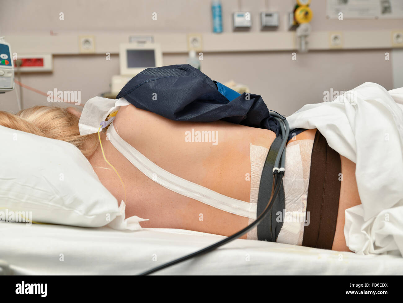 The girl lies in the birthplace with contractions and epidural anesthesia Stock Photo