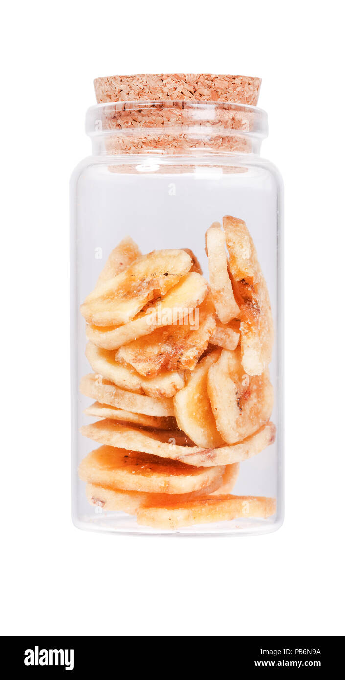 Banana chips in a glass bottle with cork stopper, isolated on wh Stock Photo