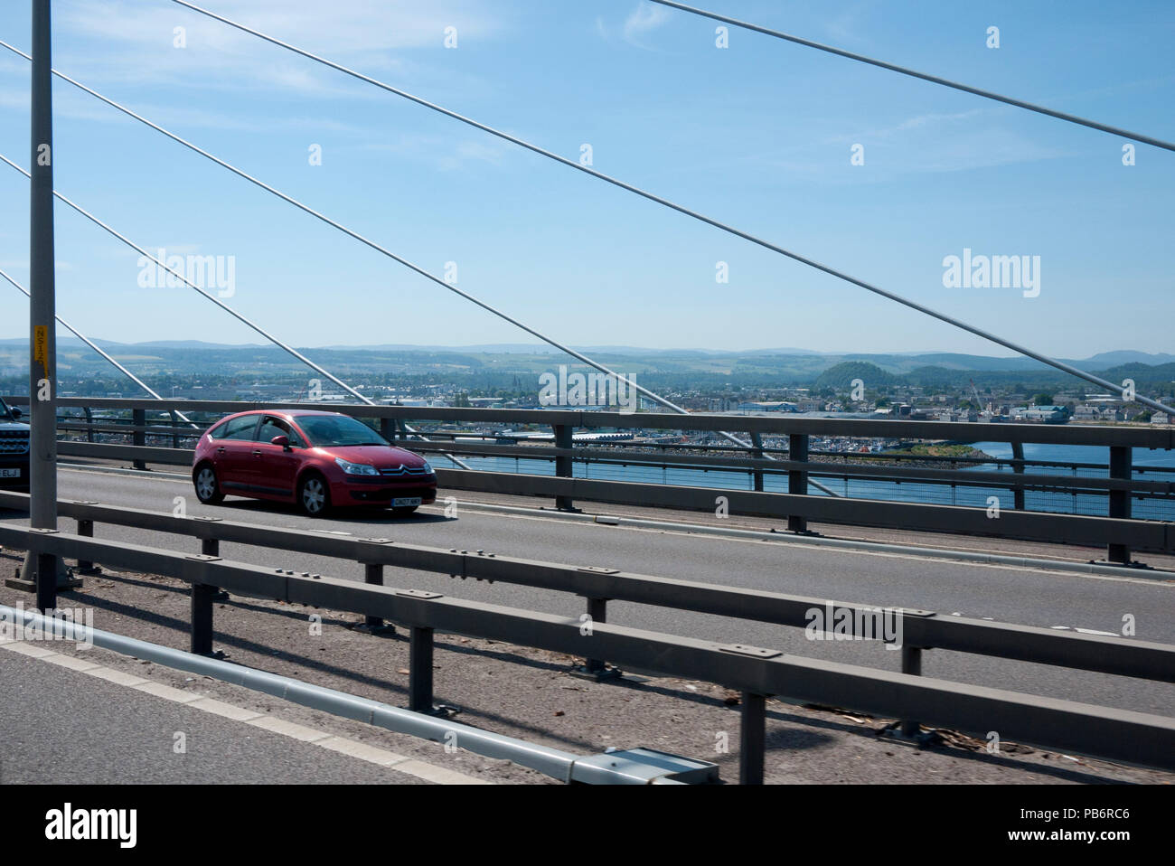 Vehicle going over the Kessock Bridge with Inverness in the background,Inverness, Highland, Scotland, UK. Stock Photo