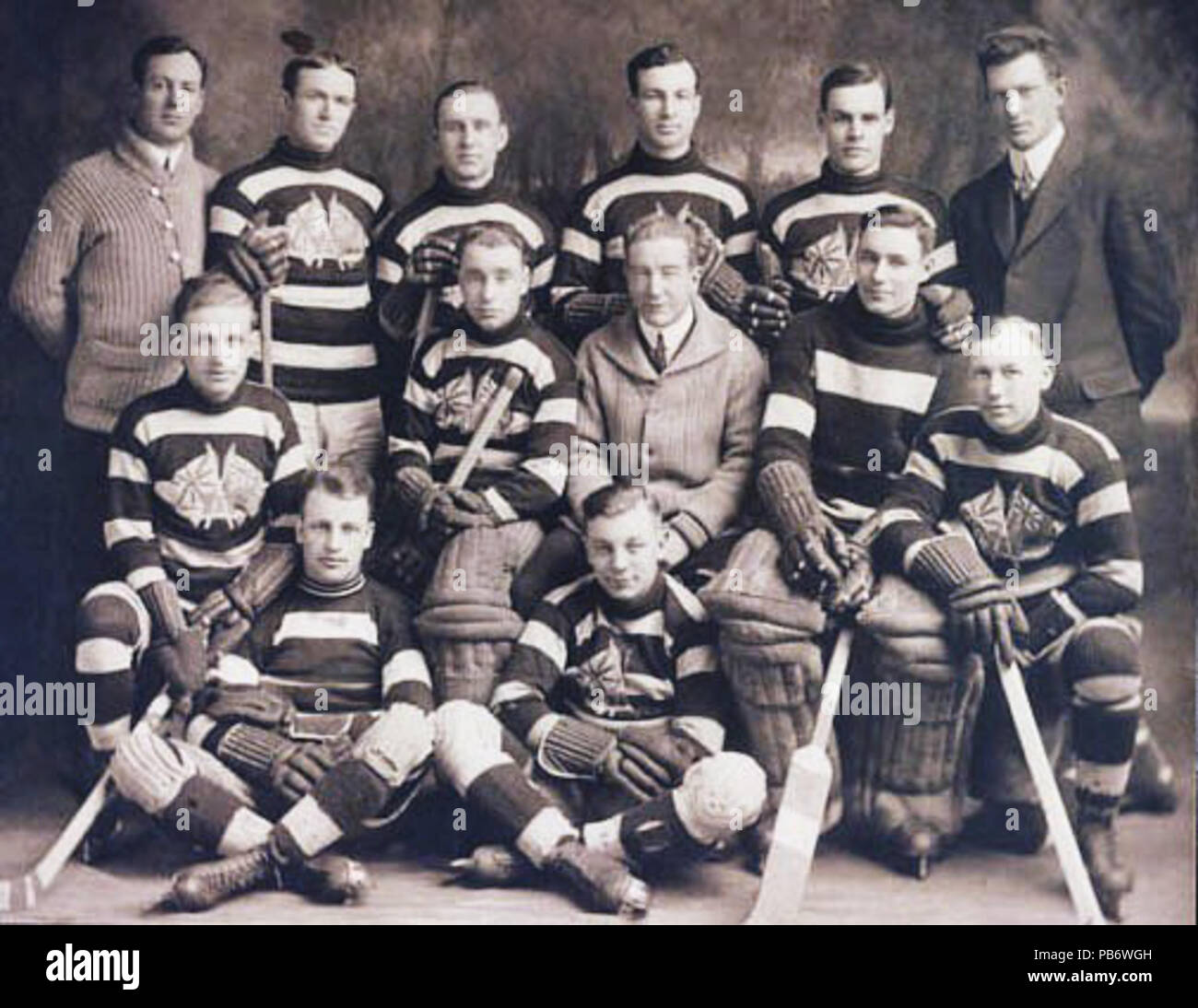 . Portrait of the Ottawa Senators. Ottawa Senators, 1914-1915 by George T. Wadds. Back Row: Cosy Dolan (trainer), Jack Darragh, Hamby Shore, Art Ross, Horace Merrill, Frank Shaughnessy (manager) Middle Row: Angus Duford, Sammy Hebert (goalie), Alf Smith (coach), Clint Benedict, Leth Graham Front Row (seated): Edie Gerard (left), Punch Broadbent . between 1914 and 1915 1144 OttawaSenators1914-15 Stock Photo