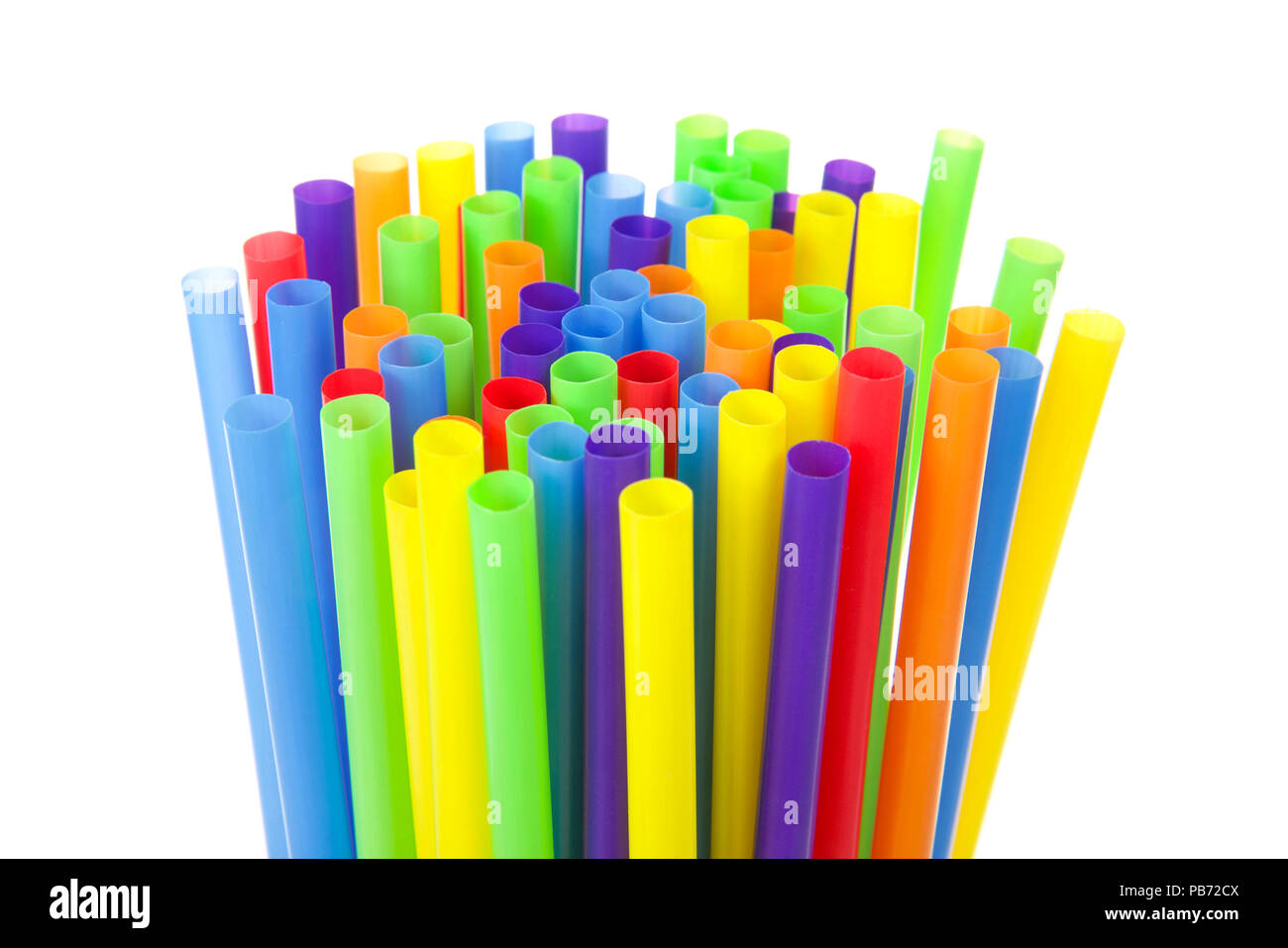 many colorful plastic straws with opening upwards isolated on white ...