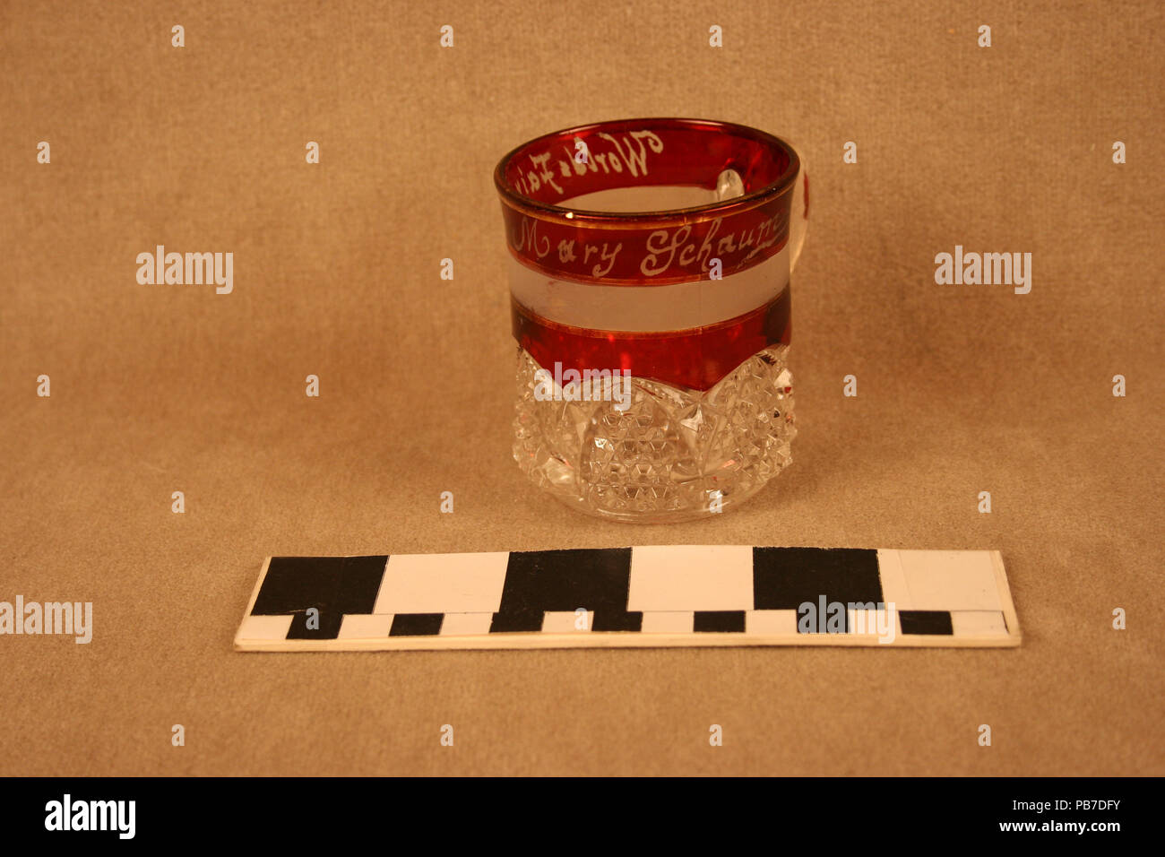 1275 Ruby Stained Mug With Button Arch Pressed Pattern Personalized to Mary Schaum Stock Photo