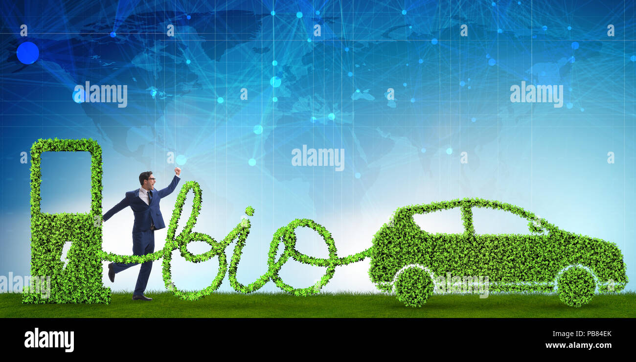 Businessman with car powered with biofuel Stock Photo - Alamy
