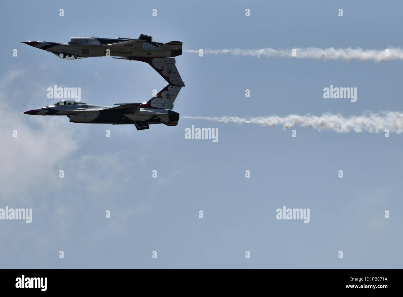 U.S. Air Force Thunderbirds perform a reflection pass during Cheyenne Frontier Days, July 25, 2018, in Cheyenne, Wyo. The Thunderbirds fly closely in formation and make close passes at intense speeds during their shows showcasing their skills as an aerial acrobatics team. The airshow provides a chance for the local community and worldwide visitors of CFD to see the U.S. Air Force in action over the skies of Cheyenne. (U.S. Air Force photo by Airman 1st Class Braydon Williams) Stock Photo
