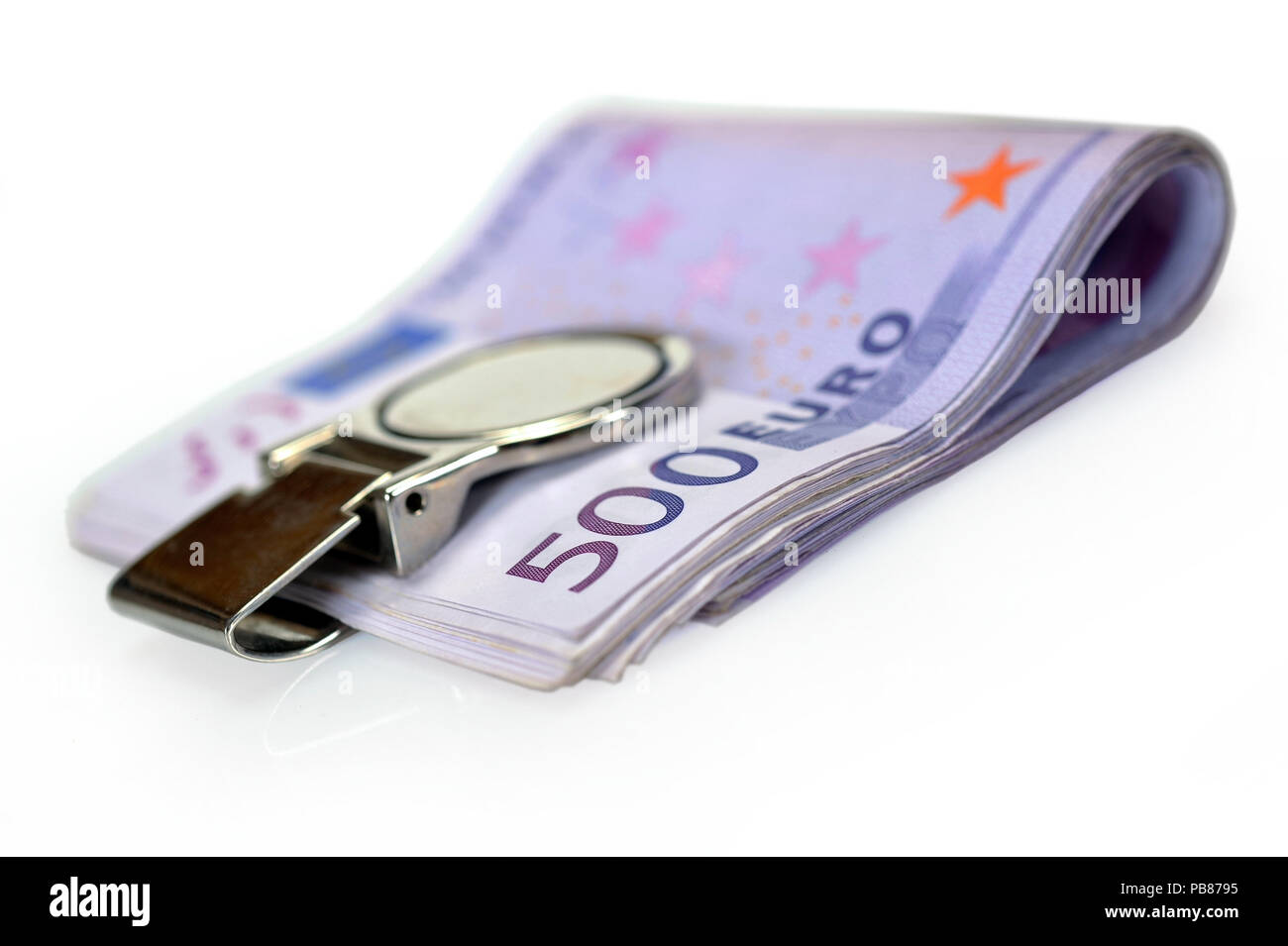 Bundle of 500 Euro bank notes fasten with money clip isolated on white background Stock Photo