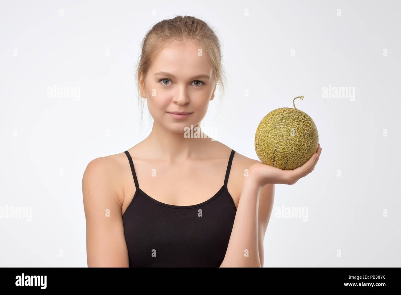beautiful woman with perfect skin holding melon Stock Photo Alamy