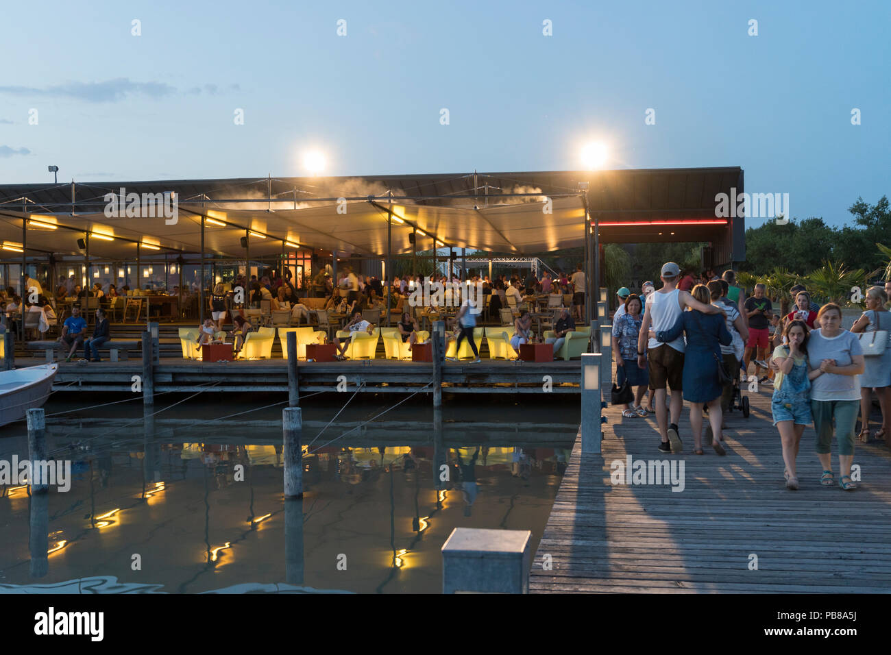 Tourists at the Mole West bar and restaurant at dusk, Neusiedl am See, Burgenland Stock Photo