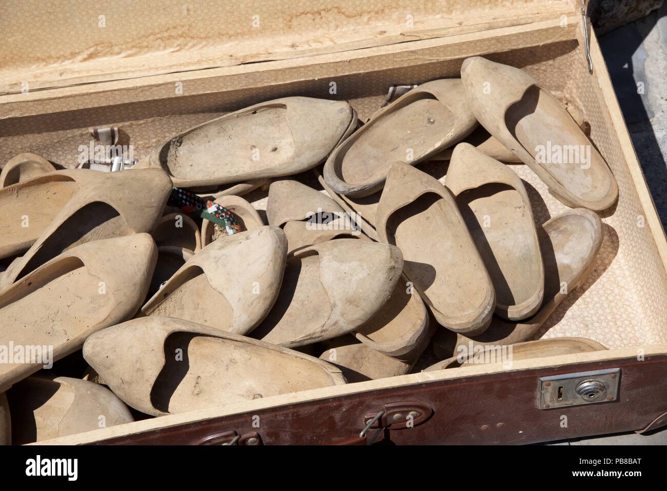 A French Brocante: a suitcase full of wooden clogs Stock Photo