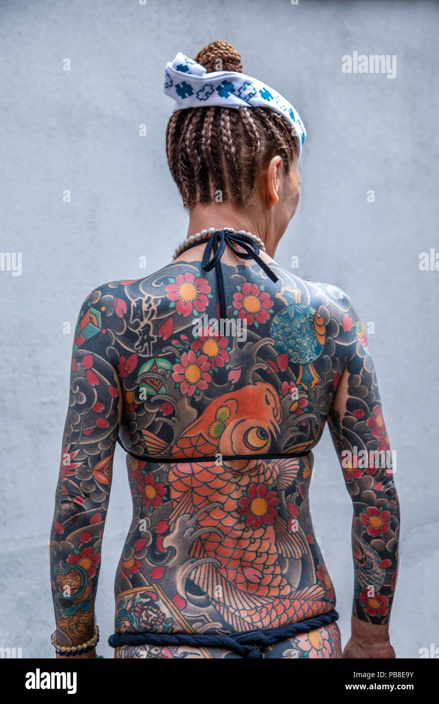 Tokyo Japan 20th May 2018 A woman showing her full body tattooed  possibly a member of the Japanese mafia or Yakuza poses for the cameras  during the Sanja Matsuri in Asakusa district