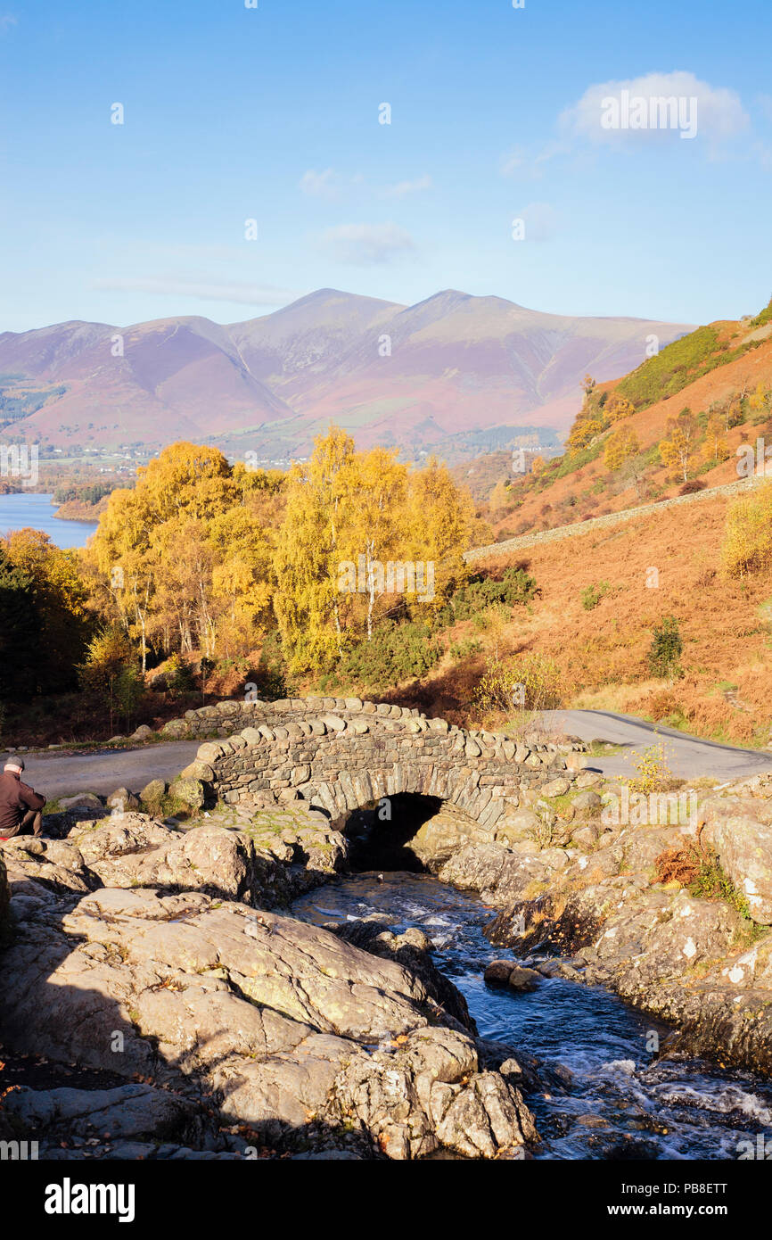 Ashness Bridge and stream with trees in autumn Skiddaw mountain beyond in Lake District National Park. Keswick Cumbria England UK Stock Photo