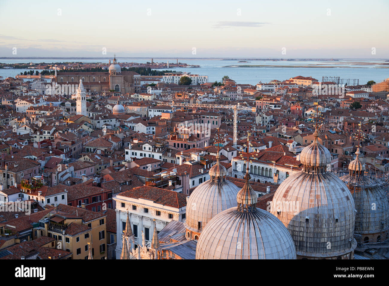 Aerial view of Venice rooftops and Saint Mark Basilica domes before ...