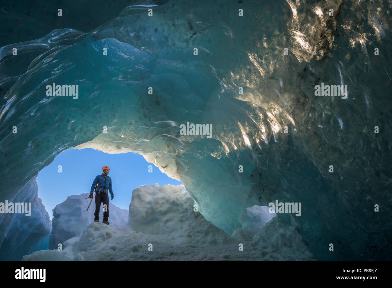 Man exploring ice cave, Vatnajokull, Iceland, March 2016. Stock Photo