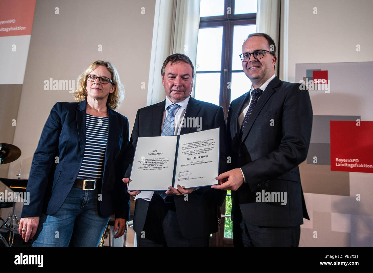 Munich, Bavaria, Germany. 27th July, 2018. Captain Claus Peter Reisch of the Mission Lifeline NGO received the Europa-Preis (Europe Award) at Bavaria's Landtag (Parliament) for his humanitarian engagement in the Mediterranean in rescuing hundreds migrants in danger of drowning. Reisch was recently arrested in Malta, facing various charges related to the use of the vessel in rescue activities. He is currently out on bail and has surrendered his passport while awaiting trial. According to the UN, some 1,500 migrants are estimated to have died while trying to cross the Mediterranean, with so Stock Photo