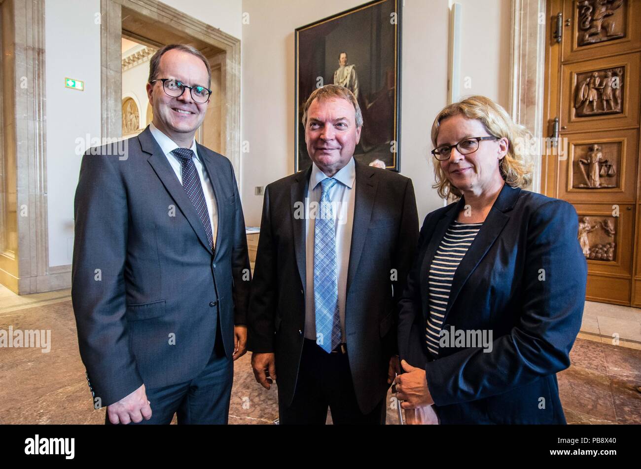 Munich, Bavaria, Germany. 27th July, 2018. MARKUS RINDERSPACHER, Lifeline Captain CLAUS PETER REISCH, NATASCHA KOHNEN. Captain Claus Peter Reisch of the Mission Lifeline NGO received the Europa-Preis (Europe Award) at Bavaria's Landtag (Parliament) for his humanitarian engagement in the Mediterranean in rescuing hundreds migrants in danger of drowning. Reisch was recently arrested in Malta, facing various charges related to the use of the vessel in rescue activities. He is currently out on bail and has surrendered his passport while awaiting trial. According to the UN, some 1,500 migrant Stock Photo