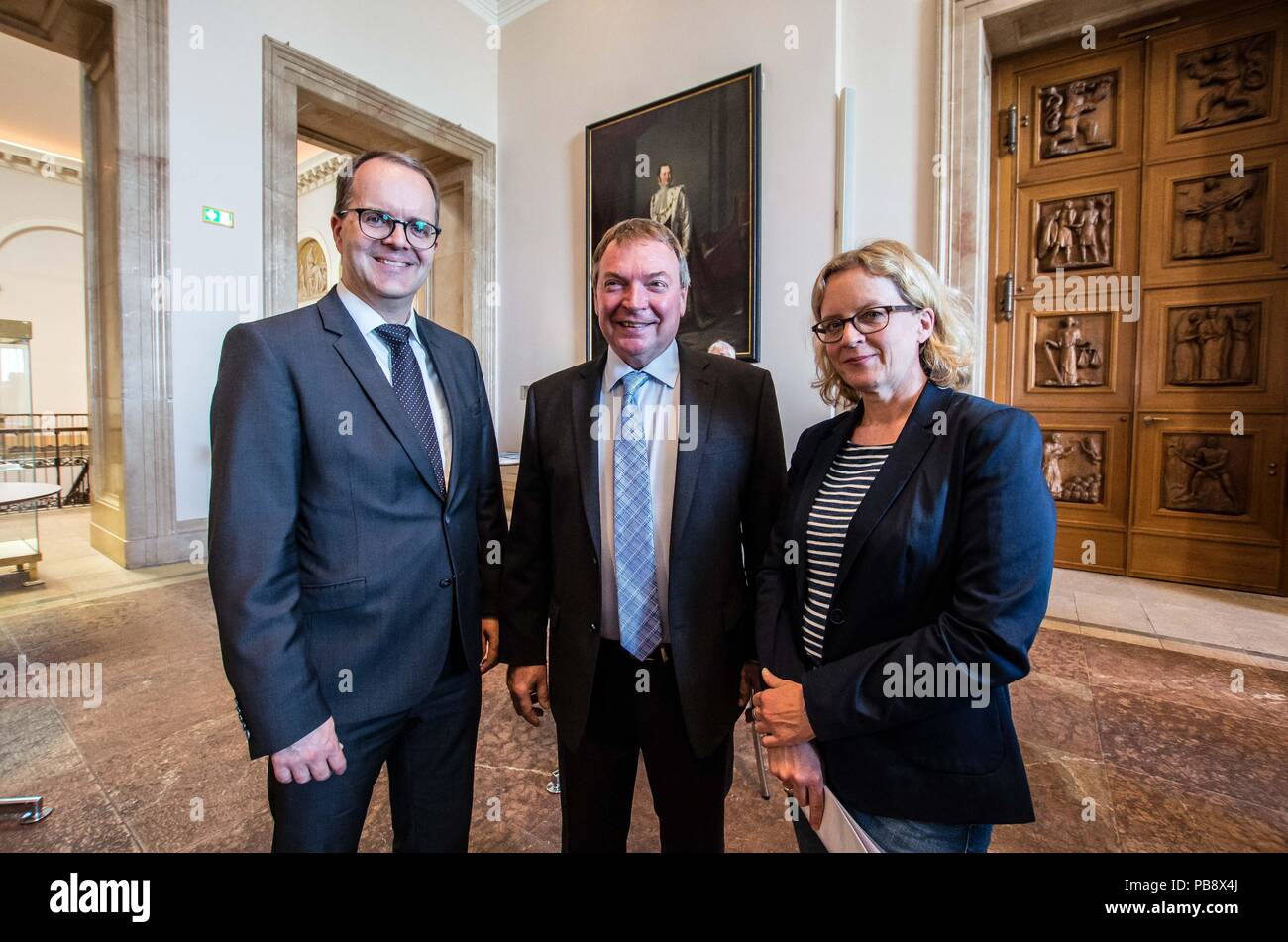 Munich, Bavaria, Germany. 27th July, 2018. MARKUS RINDERSPACHER, Lifeline Captain CLAUS PETER REISCH, NATASCHA KOHNEN. Captain Claus Peter Reisch of the Mission Lifeline NGO received the Europa-Preis (Europe Award) at Bavaria's Landtag (Parliament) for his humanitarian engagement in the Mediterranean in rescuing hundreds migrants in danger of drowning. Reisch was recently arrested in Malta, facing various charges related to the use of the vessel in rescue activities. He is currently out on bail and has surrendered his passport while awaiting trial. According to the UN, some 1,500 migrant Stock Photo