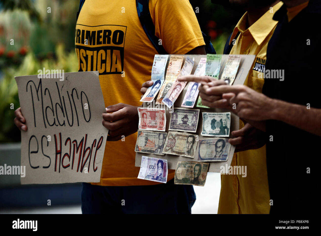 Valencia, Carabobo, Venezuela. 27th July, 2018. July 27, 2018. Youth of PJ, First Justice, protested against the economic measure of removing five (05) zeros (0) to the currency. They indicated through posters that President Nicolas Maduro is Inflation, it is hunger, it is crisis. And they showed notes of the old monetary cone that was used more than 20 years ago in the country, when the economy was solid. In Valencia, Carabobo state. Photo: Juan Carlos Hernandez Credit: Juan Carlos Hernandez/ZUMA Wire/Alamy Live News Stock Photo