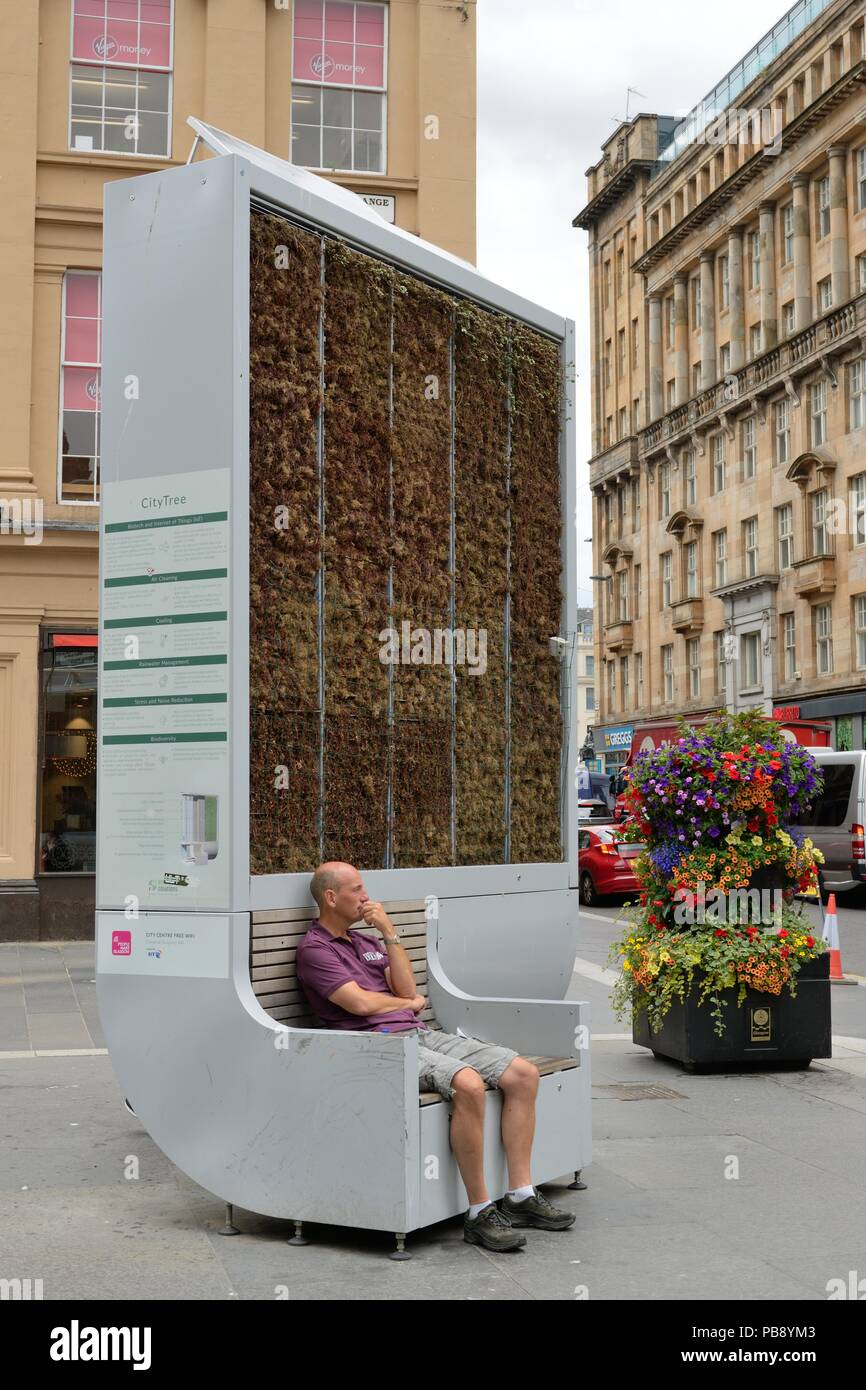 Glasgow, UK. 17th, July, 2018. Glasgow, Scotland, UK, Europe. A man takes a seat at a Glasgow 'CityTree' biodiversity unit where temperatures can be up to 17 degrees cooler as temperatures in the city reached the mid twenties. Credit: Douglas Carr/Alamy Live News Stock Photo