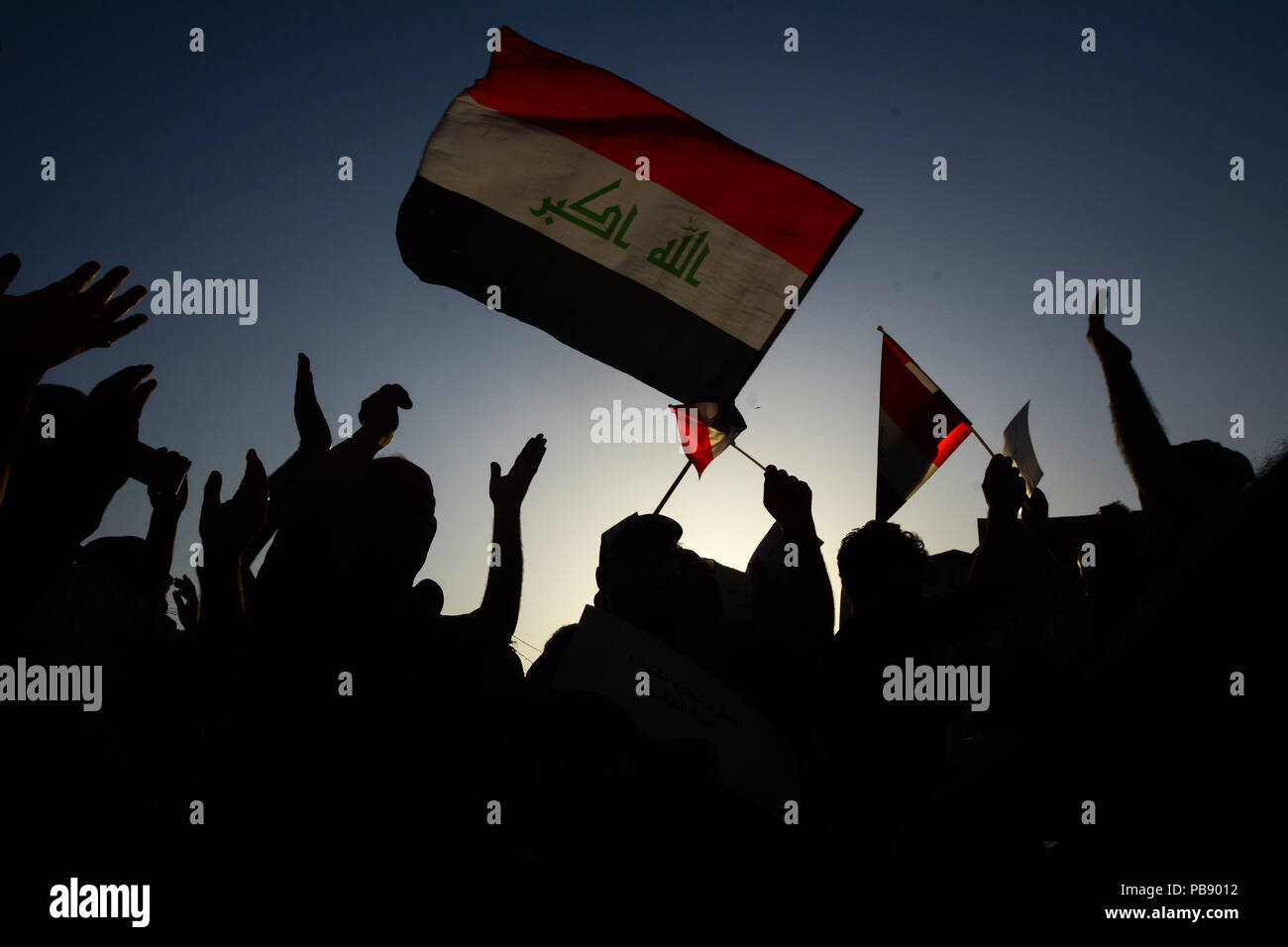 Baghdad, Iraq. 27th July, 2018. People protest against unemployment and grievances in public administration. Dozens of Iraqis went to the streets of the capital Baghdad on Friday to demand an end to widespread corruption. Credit: Ameer Al Mohammedaw/dpa/Alamy Live News Stock Photo