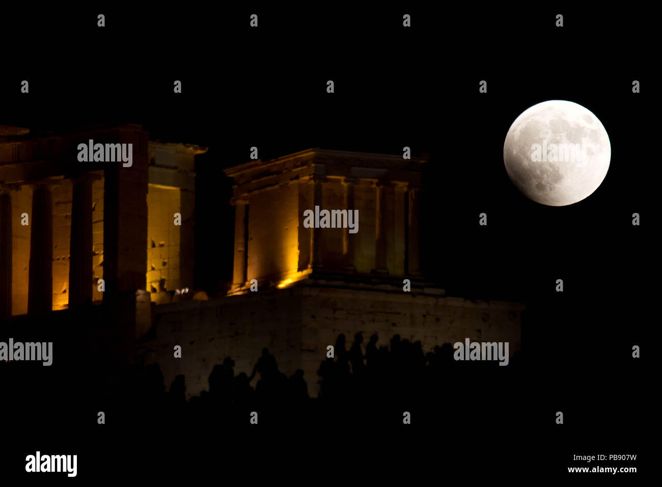 Athens, Greece. 27th July, 2018. Full moon rises over the ancient Temple of  Athena Nike in Acropolis, The complete lunar eclipse Friday when the sun,  Earth and moon line up perfectly to