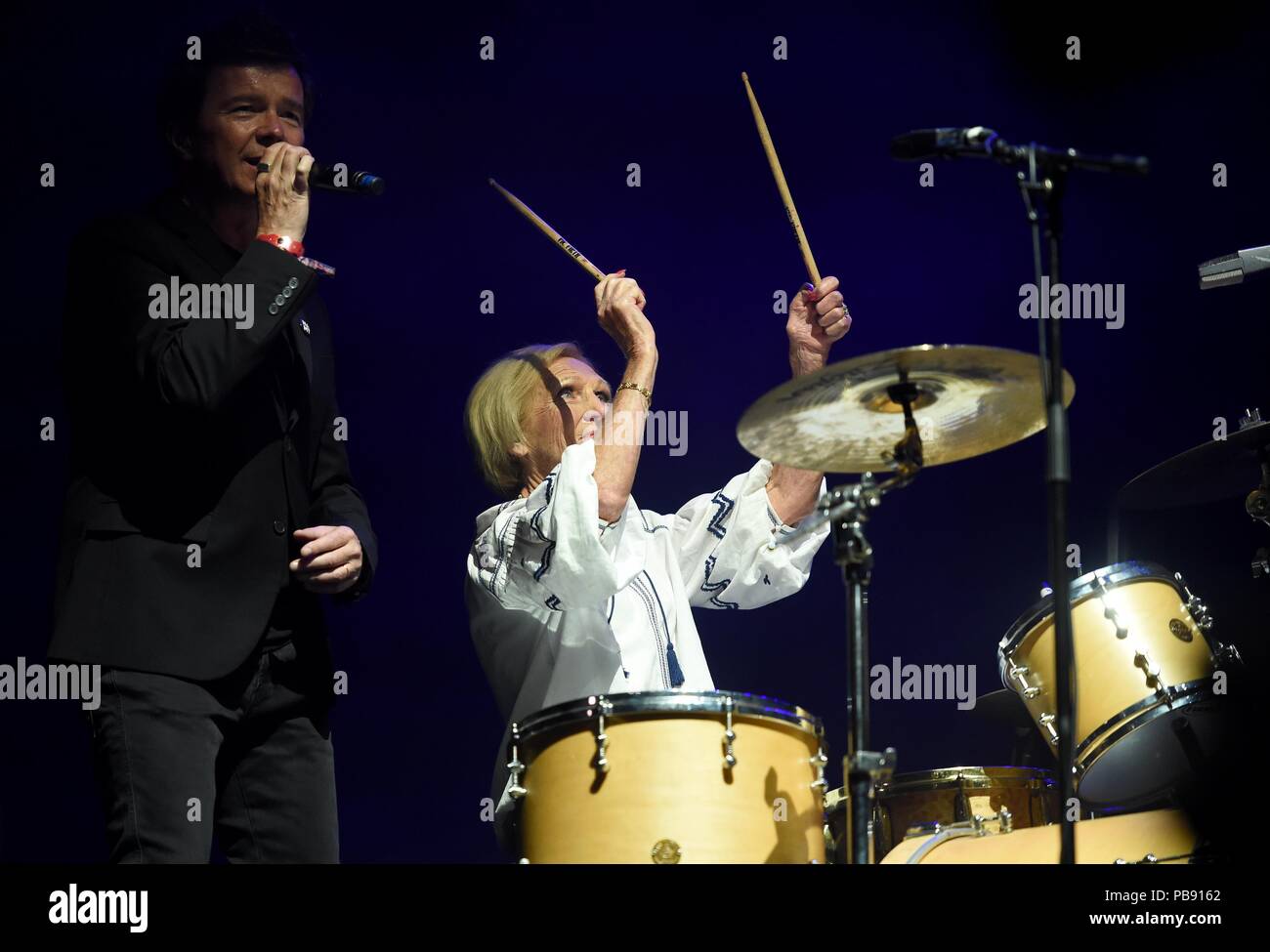 Mary Berry makes a surprise entance on drums and performs with Rick Astley Credit: Finnbarr Webster/Alamy Live News Stock Photo