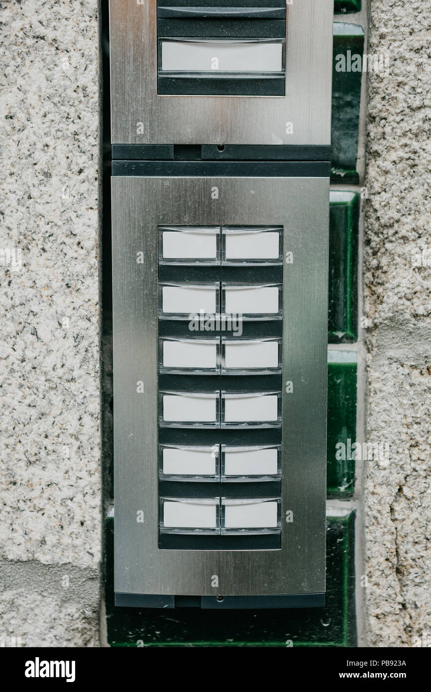 Close-up. The intercom at the entrance to the residential building. Means of communication or notification of arrival and security of the entrance inside. Stock Photo