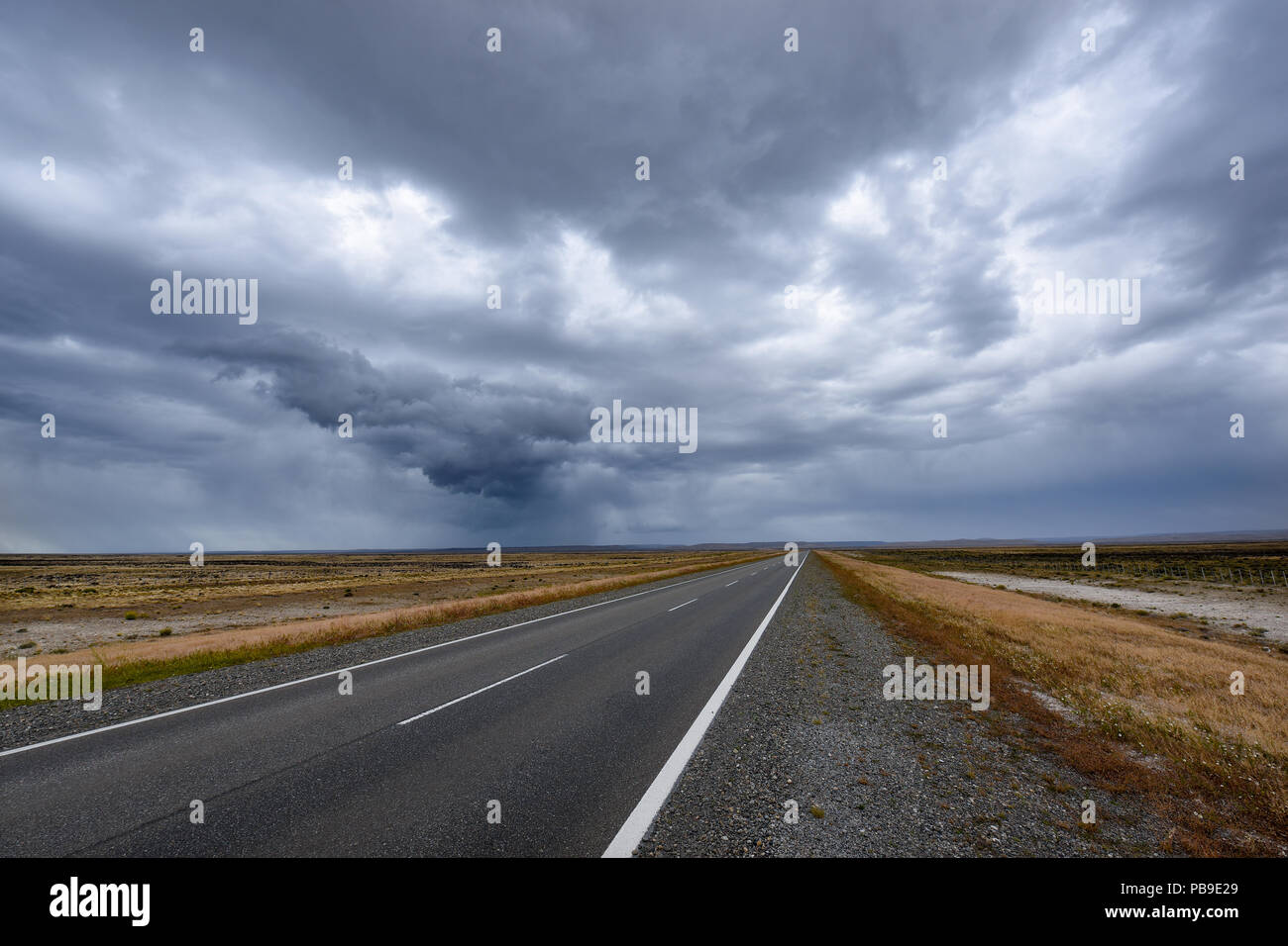 Road with thunderstorm mood by the pampa of Patagonia, near Rio Gallegos, Argentina Stock Photo