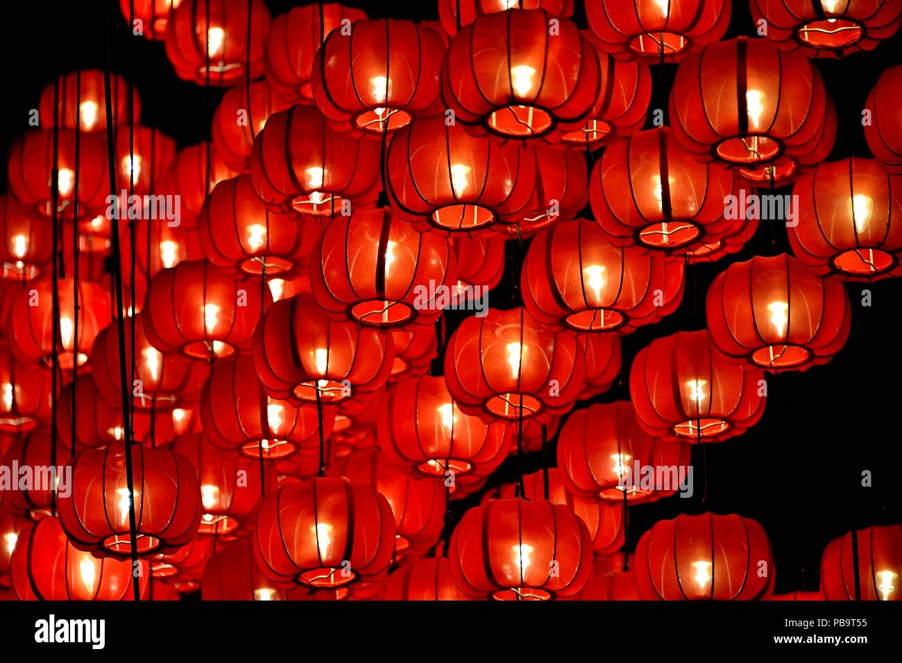 Close up of traditional red hanging Chinese lanterns celebrating festivals like Chinese New Year and mid-Autumn festival as vintage background Stock Photo