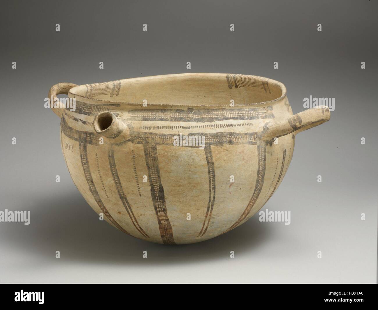 Terracotta two-handled bowl with spout. Culture: Cypriot. Dimensions: H. 8 in. (20.3 cm); diameter  11 in. (28 cm). Date: ca. 1600-1150 B.C..  Lateral handles and tubular spout, lattice ornament. Museum: Metropolitan Museum of Art, New York, USA. Stock Photo