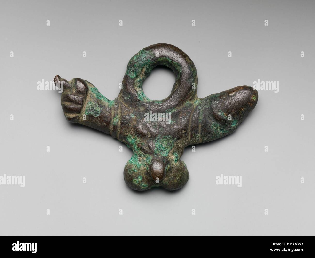 Bronze phallic amulet. Culture: Roman. Dimensions: W. 2 7/8 in. (7.3 cm.). Date: 1st century A.D..  This amulet incorporates three different symbols: the phallus, male genitalia, and the mano fica (a rude hand gesture). All three were potent apotropaic devices intended to ward off the Evil Eye. Museum: Metropolitan Museum of Art, New York, USA. Stock Photo