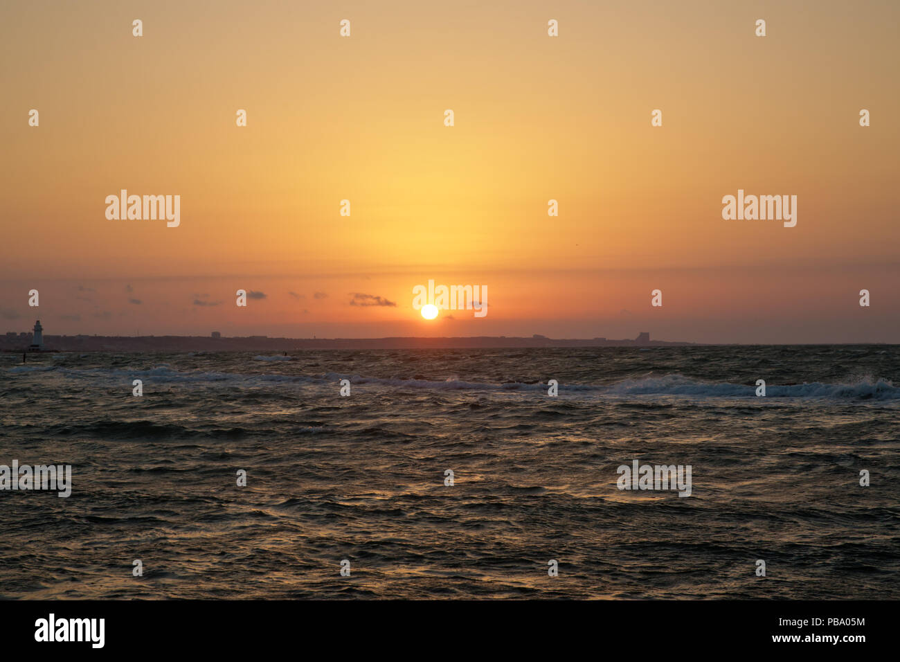 The fisherman fishes in the sea . Beautiful sunset at the beach ...