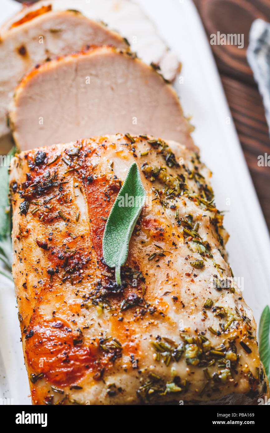 Sliced pork loin roasted . Recipe with herbs Stock Photo Alamy