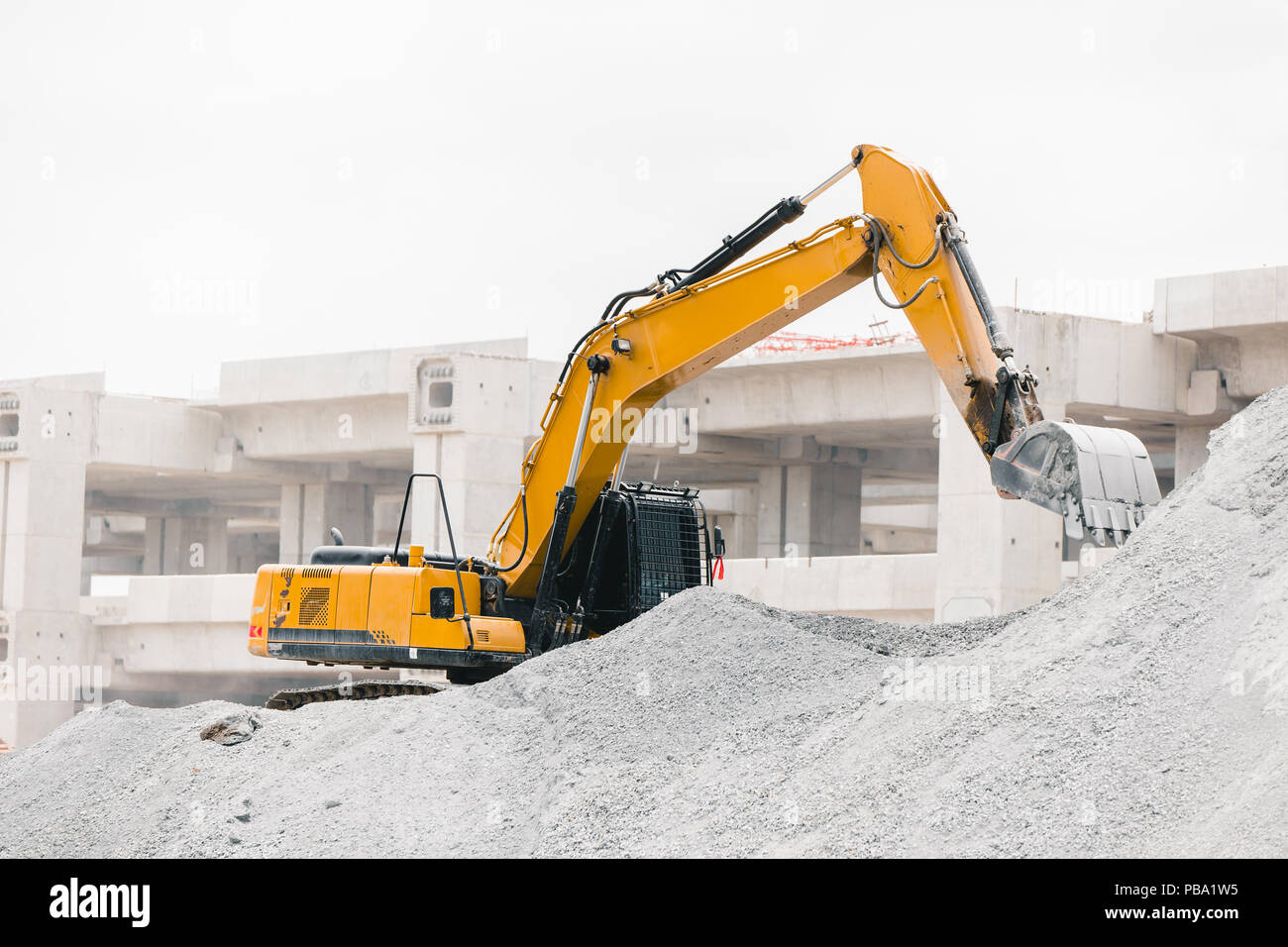 Excavator working at the construction site rock moving for building tollway Stock Photo