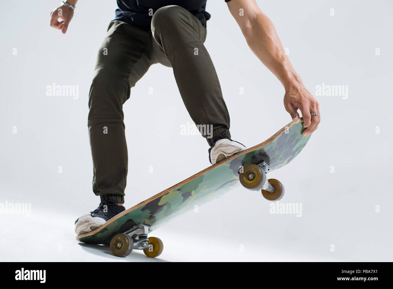 Young Chinese man skateboarding Stock Photo