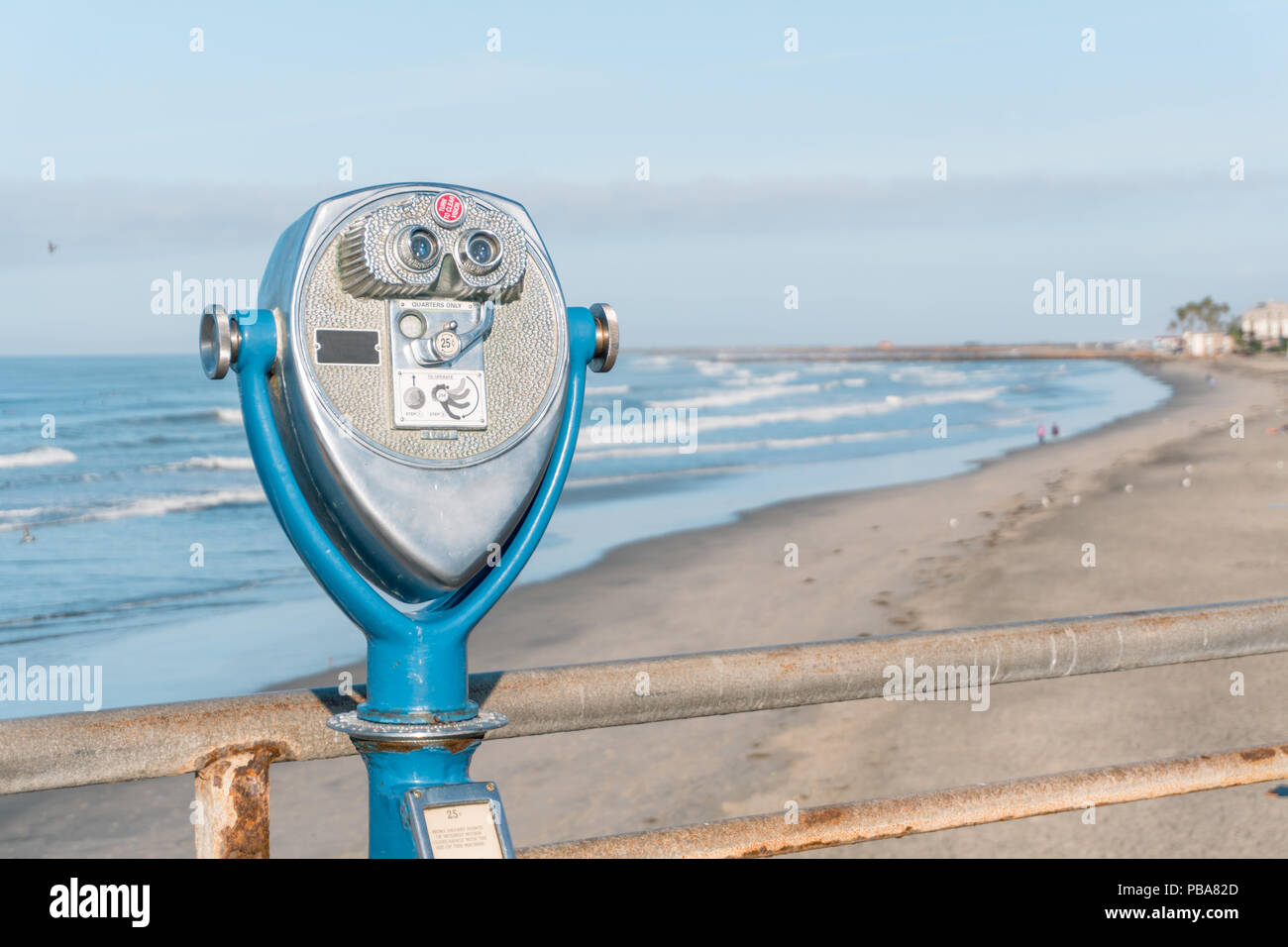 OCEANSIDE, California (EUA) - November 10, 2017: Antique coin operated binoculars at Oceanside Pier, and the beach on the background Stock Photo