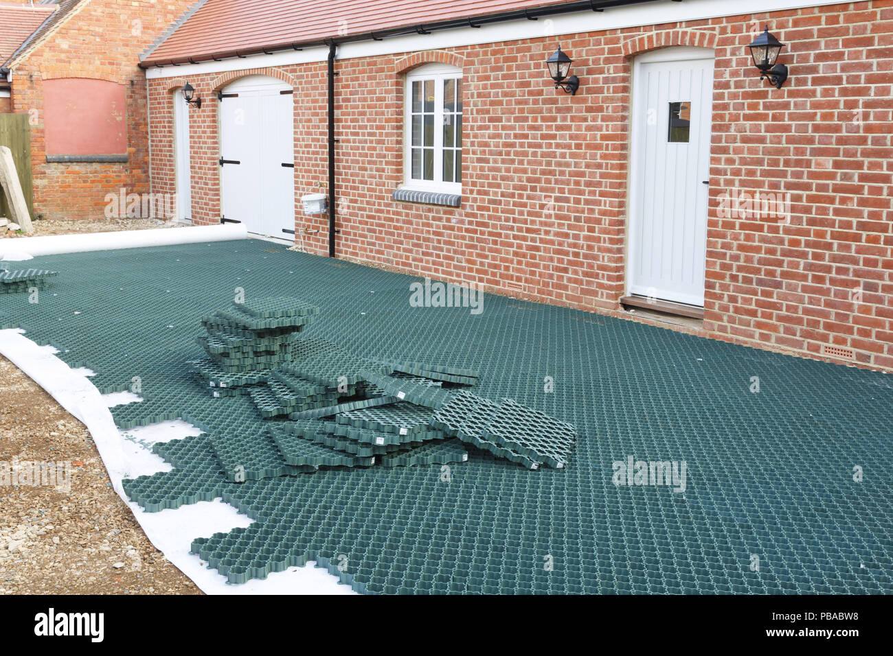 Ground guard grid system installed into a domestic parking area prior to covering with gravel Stock Photo