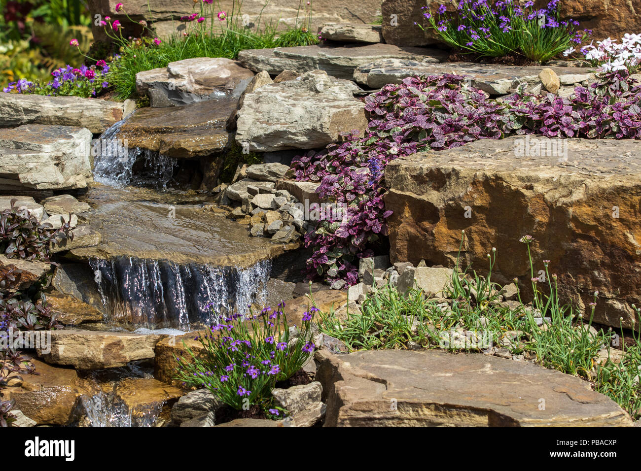 A beautiful garden rockery with  a waterfall Stock Photo