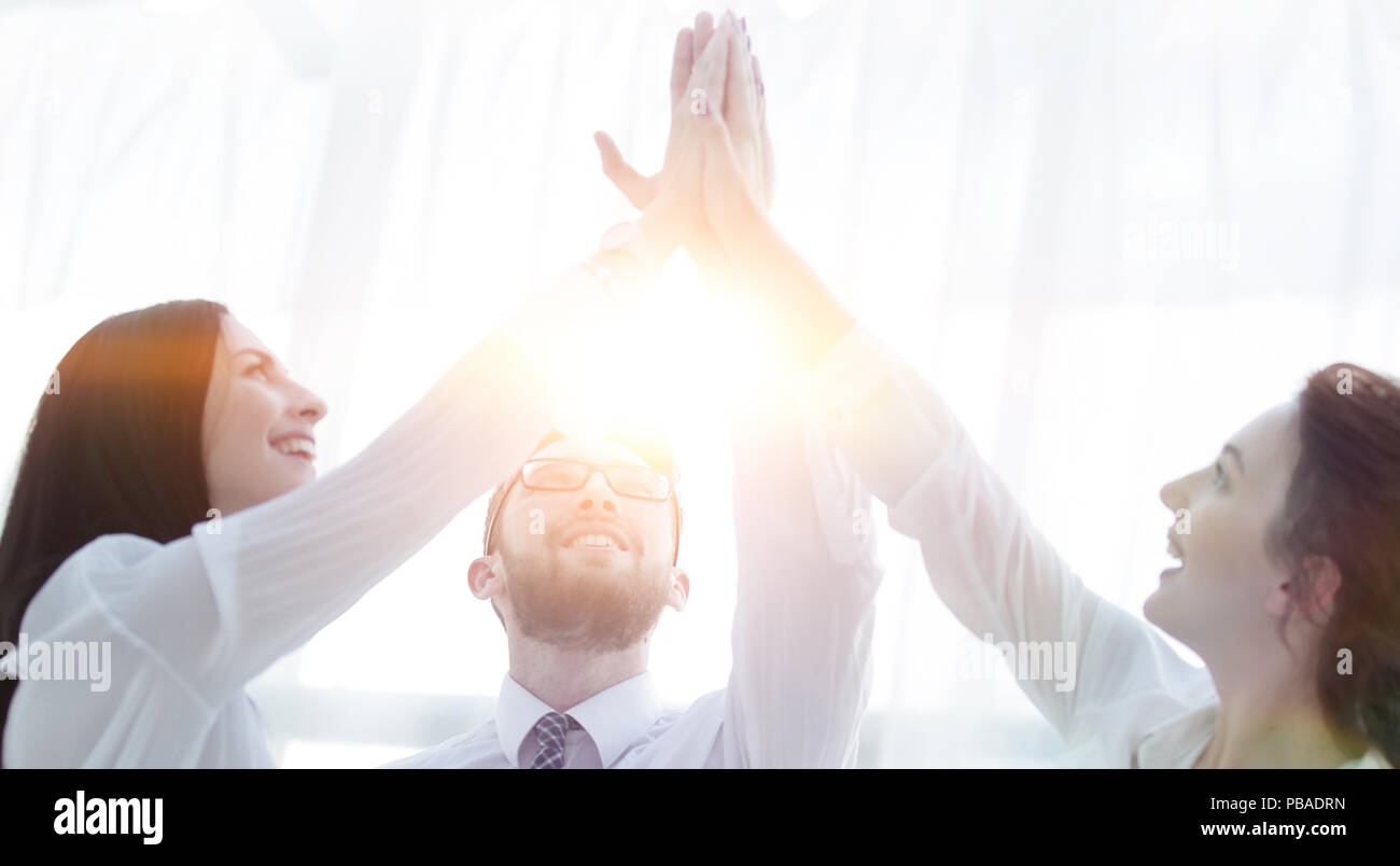 happy colleagues giving each other a high five Stock Photo - Alamy