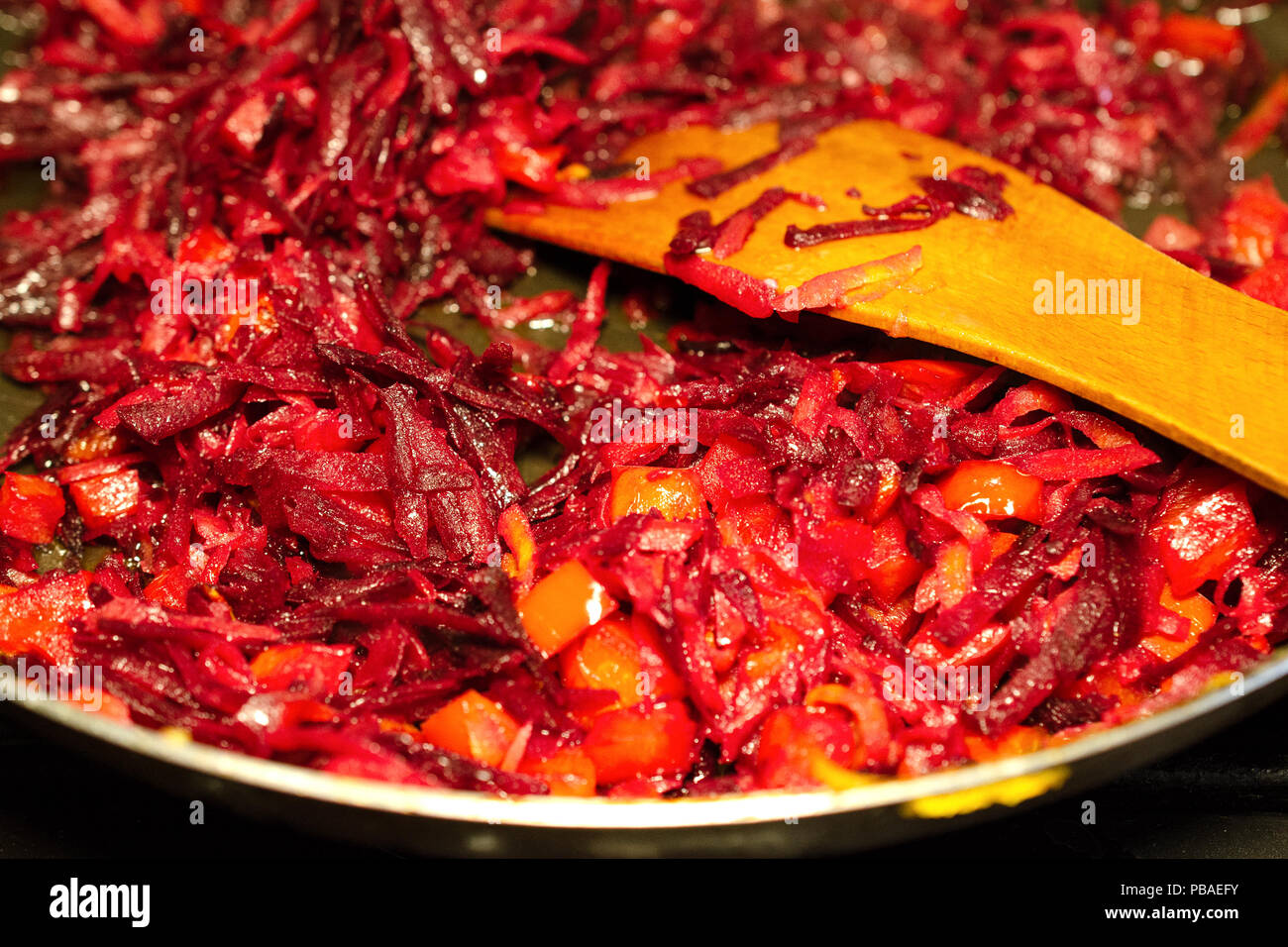 Adding vegetables in a frying pan hires stock photography and images