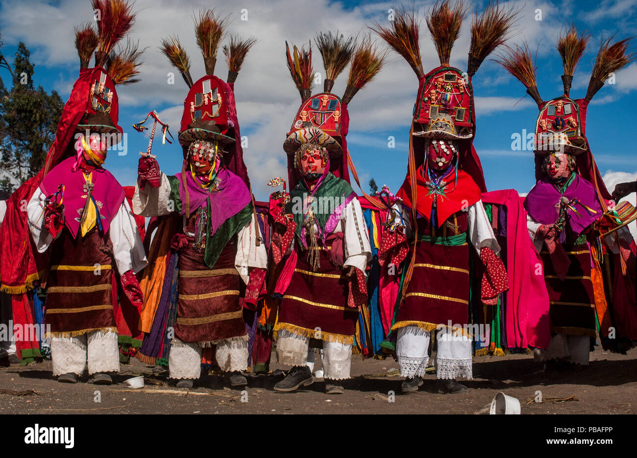 Indigenous Salasaca Indians in traditional masks and headdresses, celebrating the Inti Raymi festival - or Festival of the Sun, Salasaca, Andes, Ecuador, June 2004. Stock Photo