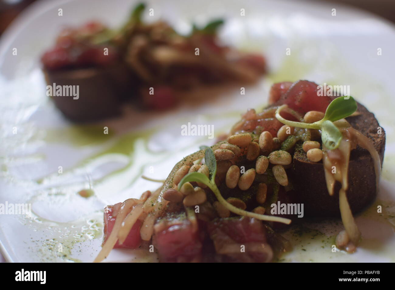 Russian cuisine - Appetizer with red tuna on a slice of dark bread Stock Photo