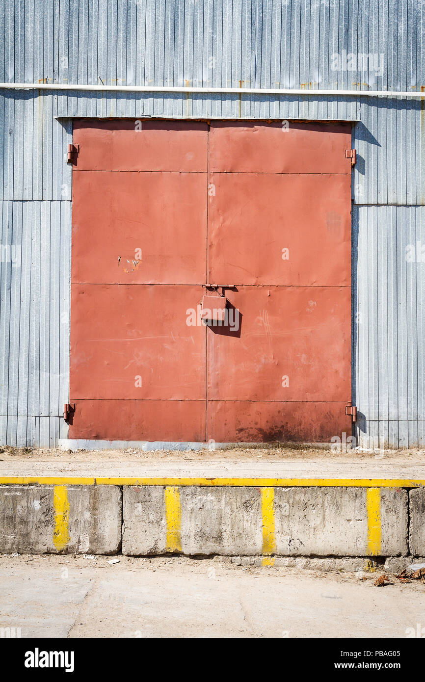 Old metal warehouse door, hangar gate. Industrial iron door. Stock Photo