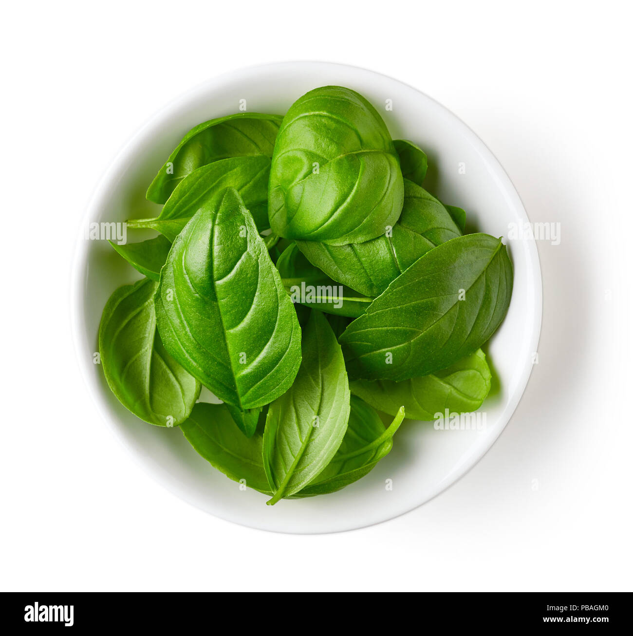 Bowl of basil leaves isolated on white background, top view Stock Photo ...