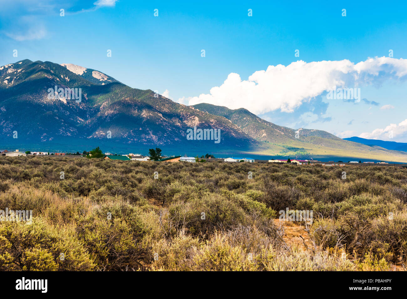 TAOS, NM, USA-7 JULY 18: A small residential community sets at the base of mountains surrounding the town of Taos. Stock Photo