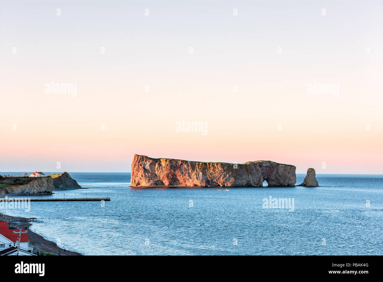 Rocher perce perce rock at sunset village of perce hires stock