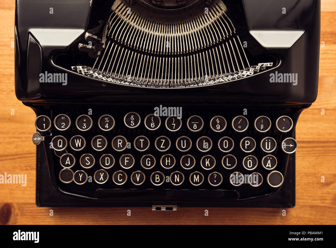 Vintage typewriter machine on writers desk, top view flat lay conceptual image for blogging, publishing, journalism or poetry writing. Stock Photo