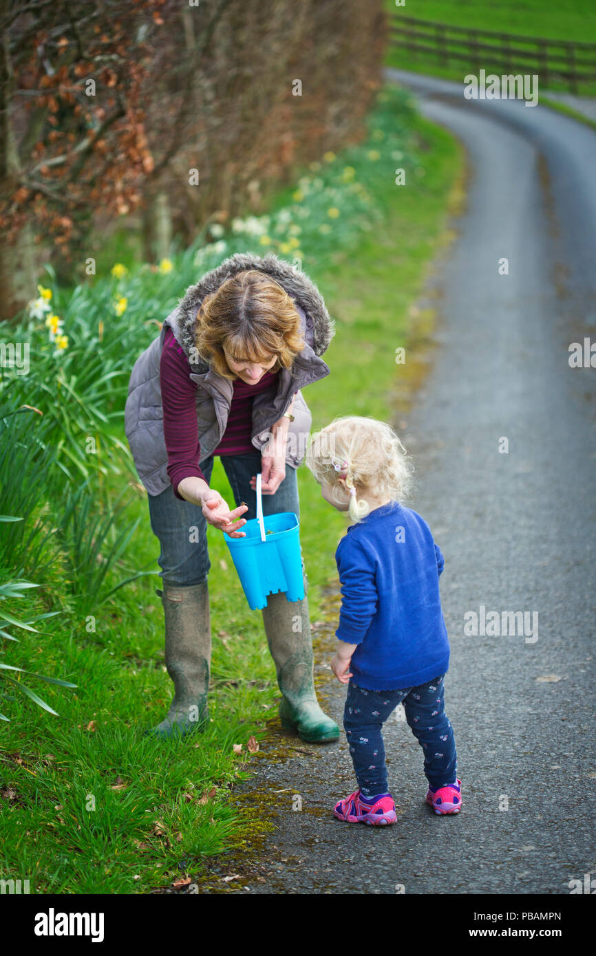 A happy 2 year old girl outdoors with her grandmother Stock Photo