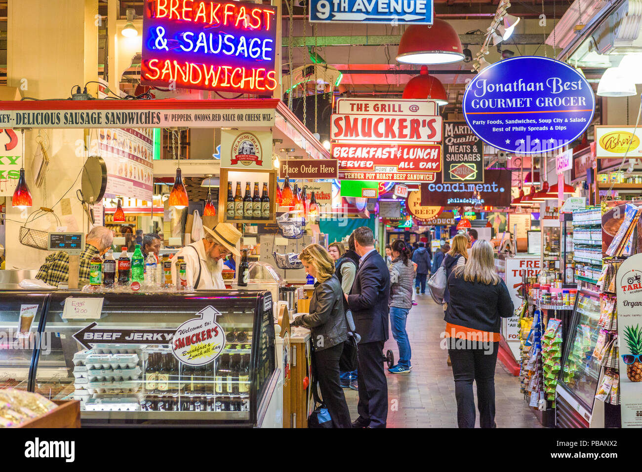 PHILADELPHIA, PENNSYLVANIA - NOVEMBER 18, 2016: Vendors and customers in Reading Terminal Market. The historic market is a popular attraction for culi Stock Photo