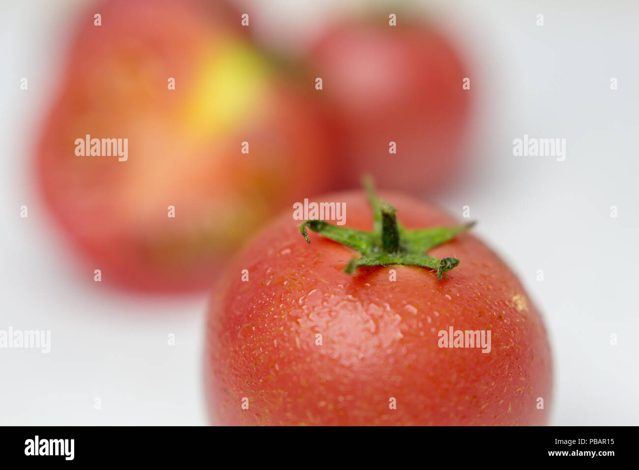 Fresh tomatoes on white background. Top view. With splashes of water ...